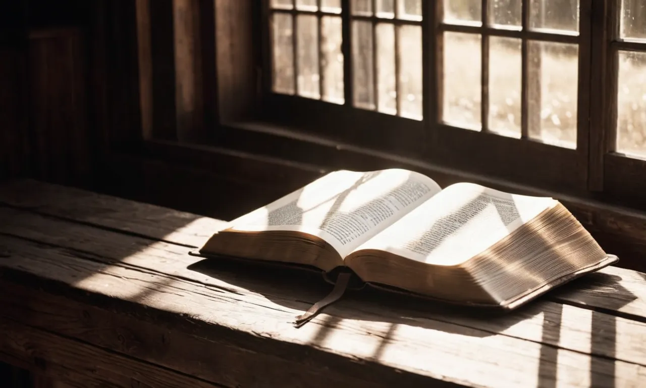 A black and white photo of an open Bible resting on a weathered wooden table, with rays of sunlight streaming through a nearby window, casting a warm glow on its pages.